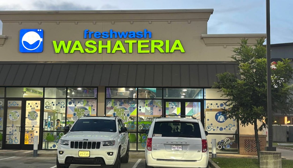 Fresh Wash Washateria storefront with the freshwash Washateria sign and Wash, Dry & Fold window decals